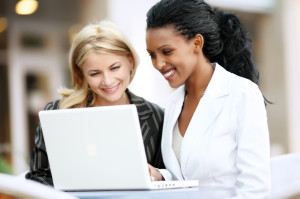Businesswomen working on laptop.